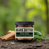 Jar of Palo Peak Beard Butter surrounded by palo santo sticks and spearmint leaves