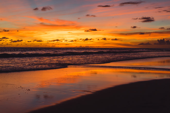 Sunset over a beach with orange and purple hues